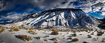 Snowy Mountain Landscape with Dramatic Clouds and Sagebrush