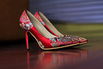Red Embroidered Chinese High Heels on Wooden Surface
