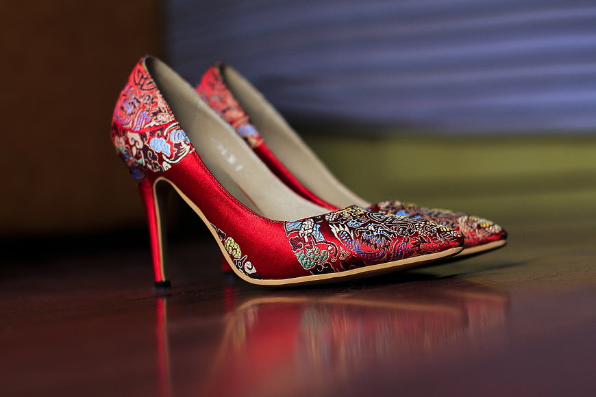 Red Embroidered Chinese High Heels on Wooden Surface