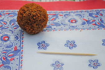 Dutch bitterball on patterned napkin with toothpick