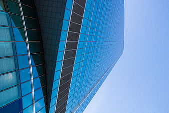 Low angle view of modern blue glass skyscraper architecture