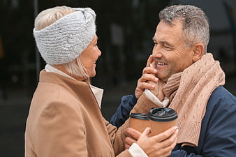 Happy Senior Couple Sharing Coffee and Laughter Outdoors