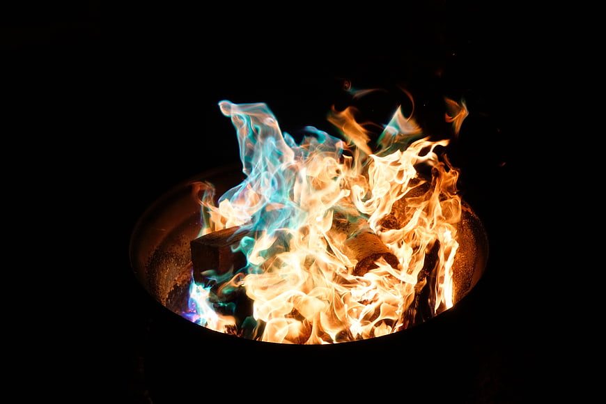 Vibrant Blue and Orange Flames Burning in a Fire Pit