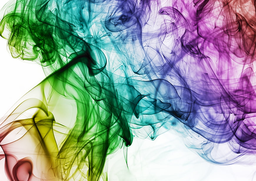 Abstract rainbow colored smoke swirling on white background