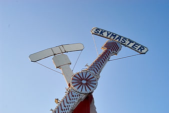 Vintage Skymaster carnival ride against clear blue sky