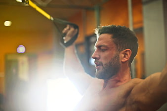 Muscular Man Exercising with Resistance Bands in Gym