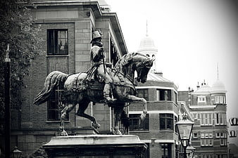 Black and white equestrian statue in urban setting