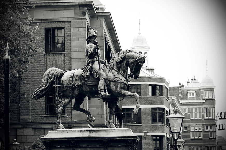 Black and white equestrian statue in urban setting