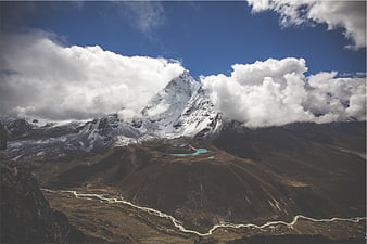 Majestic Snow-Capped Mountain Peak with Turquoise Lakes and River