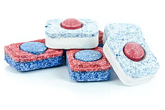 Colorful dishwasher detergent tablets on white background