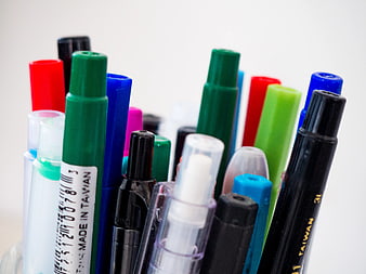 Close-up of colorful pens and markers in a container