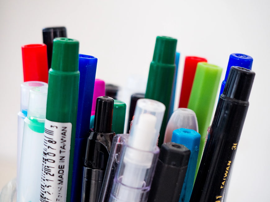 Close-up of colorful pens and markers in a container