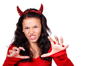 Young woman in red devil costume making aggressive face