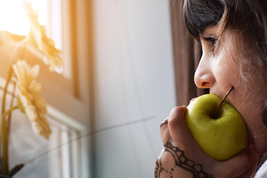 Girl Eating Green Apple by Window with Henna