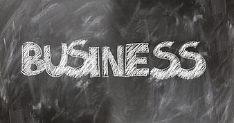 Business word written in chalk on blackboard