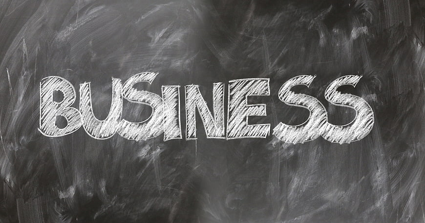 Business word written in chalk on blackboard