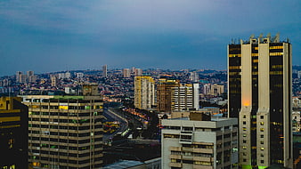 Cityscape at Dusk with Skyscrapers and Traffic