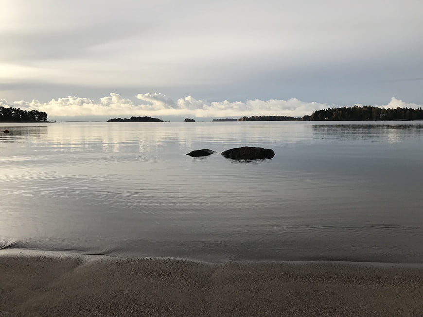 Serene coastal landscape with calm water and distant islands