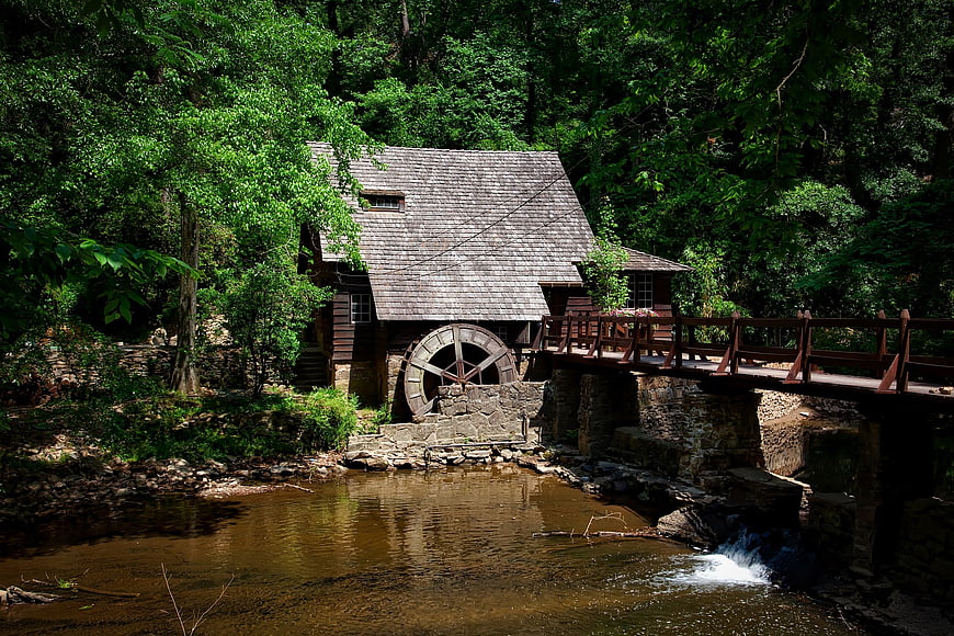 Historic wooden grist mill with water wheel by river