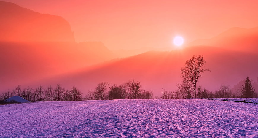 Vibrant Pink and Purple Winter Sunrise Over Snowy Mountain Landscape