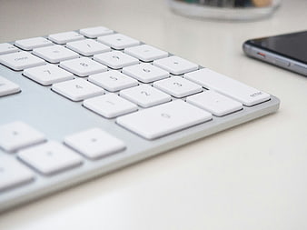 Close-up of white calculator keyboard on desk