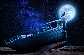 Old wooden boat on shore under full moon and starry night sky