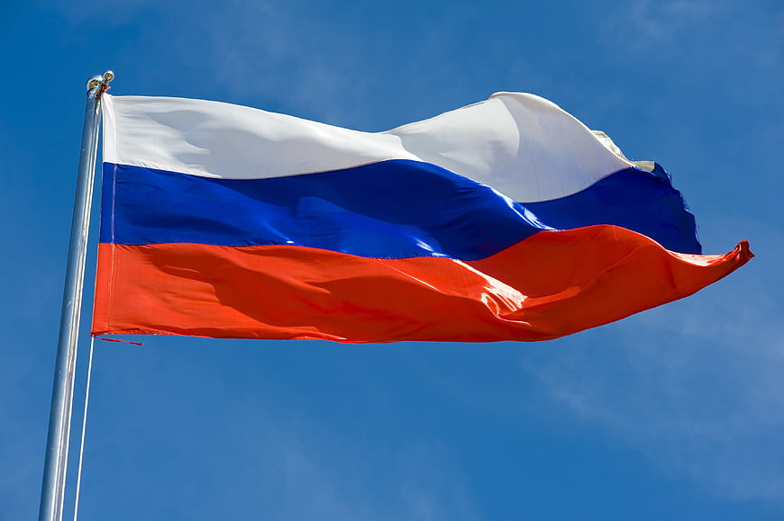 Russian flag waving against a clear blue sky