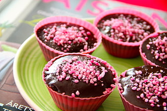 Chocolate Muffins With Pink Sprinkles On Green Plate