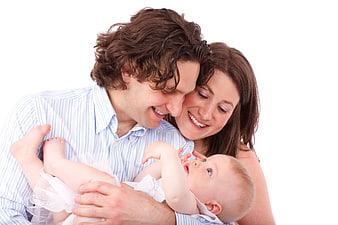 Happy family portrait with father, mother, and baby on white background
