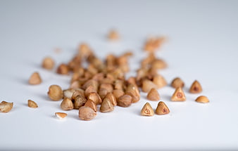 Scattered Raw Buckwheat Groats On White Background
