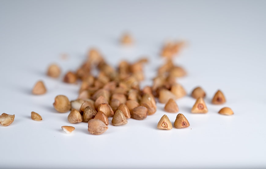 Scattered Raw Buckwheat Groats On White Background