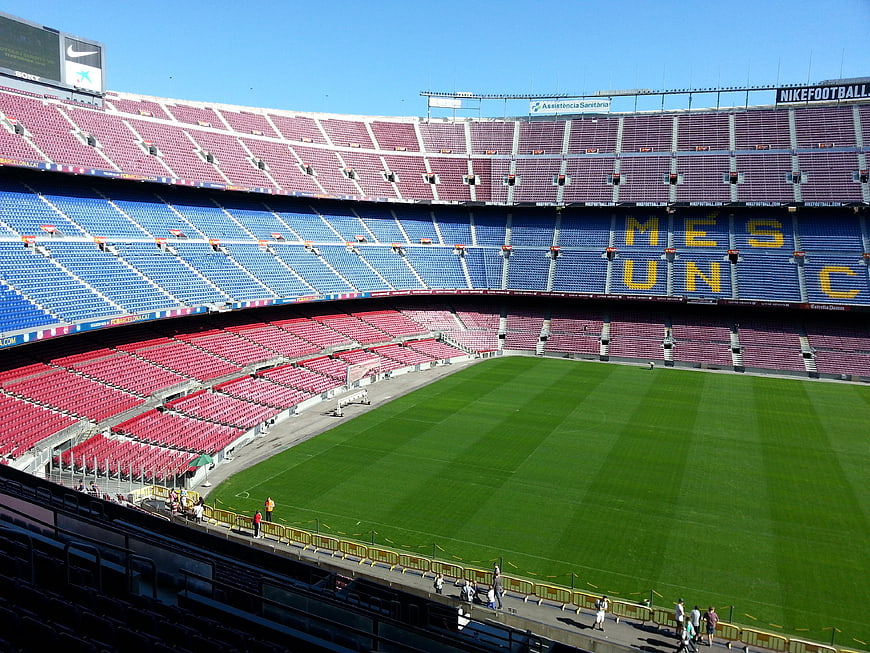 Camp Nou Football Stadium Interior With Colorful Seating And Green Pitch