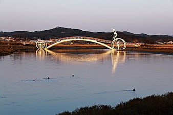 Bicycle Pedestrian Bridge Over Calm River At Dusk