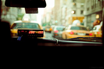 Taxi Meter View Through Windshield in City Traffic