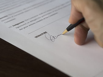 Hand Signing a Business Contract Document