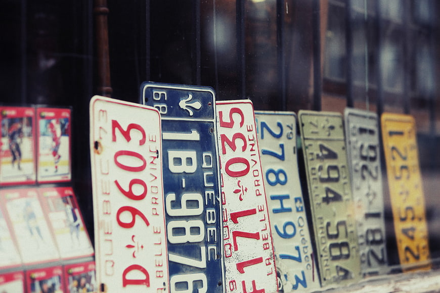 Vintage Quebec License Plates Displayed in Shop Window