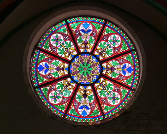 Colorful circular stained glass rosette window in church