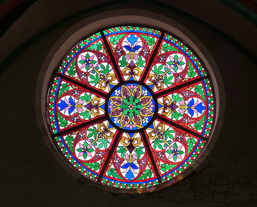 Colorful circular stained glass rosette window in church