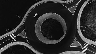 Aerial View of Roundabout with Single White Car