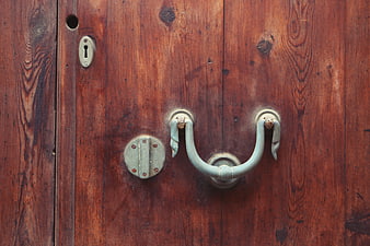 Close-up of vintage wooden door with antique metal handle
