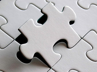White Jigsaw Puzzle Piece Hovering Over Missing Gap