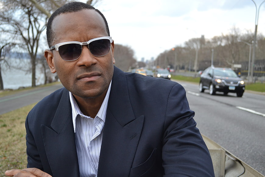 Confident African American Man in Suit and Sunglasses by Road