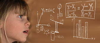 Young girl looking at floating math equations and formulas