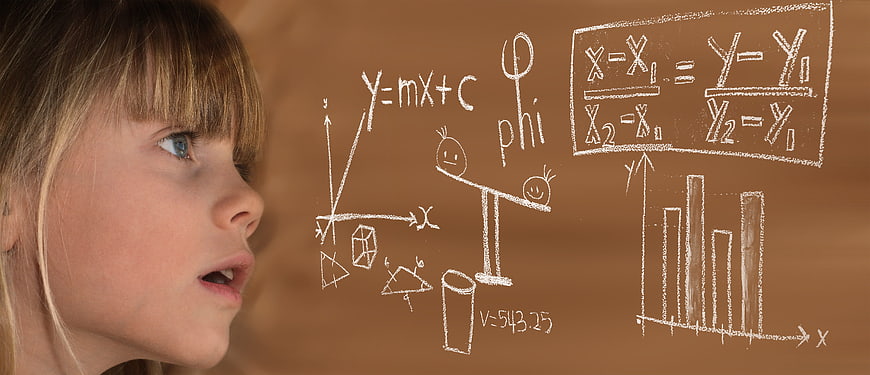 Young girl looking at floating math equations and formulas