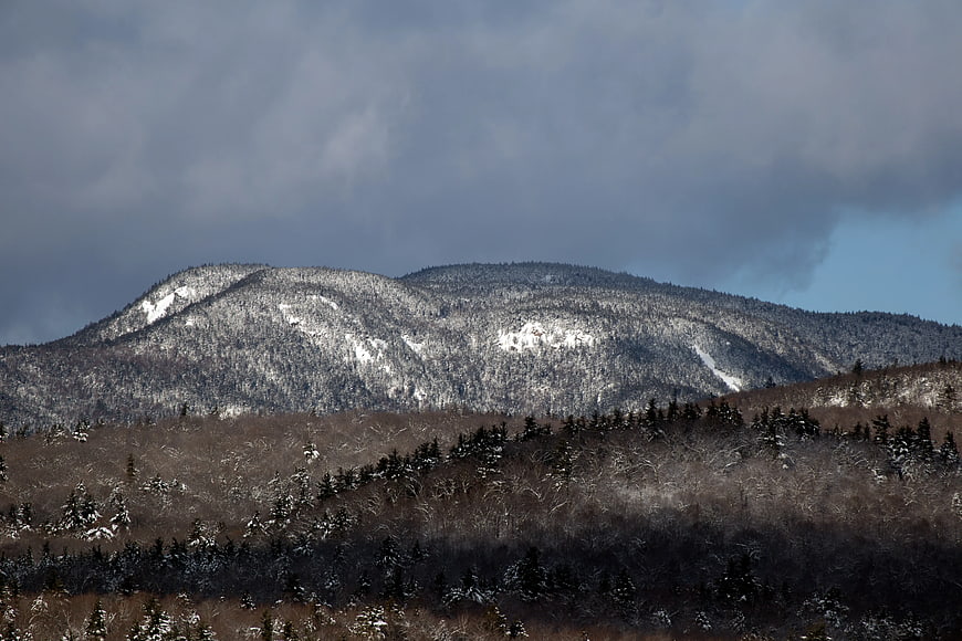 Snowy Mountain Range Under Dramatic Cloudy Sky