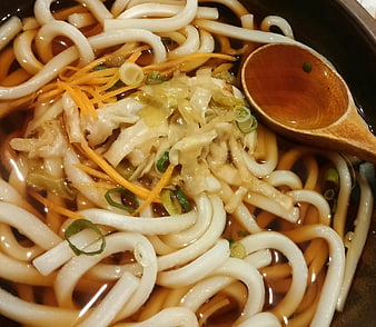 Japanese Udon Noodle Soup With Toppings And Wooden Spoon