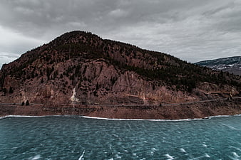 Aerial view of rugged mountain coastline with turquoise water