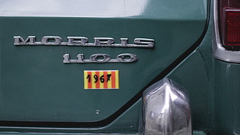 Close-up of vintage Morris 1100 car badge and 1967 sticker