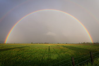 Double Rainbow Arching Over Green Pasture Field