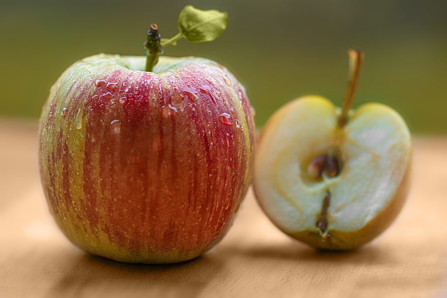 Fresh Red Apple with Water Droplets and Cut Half